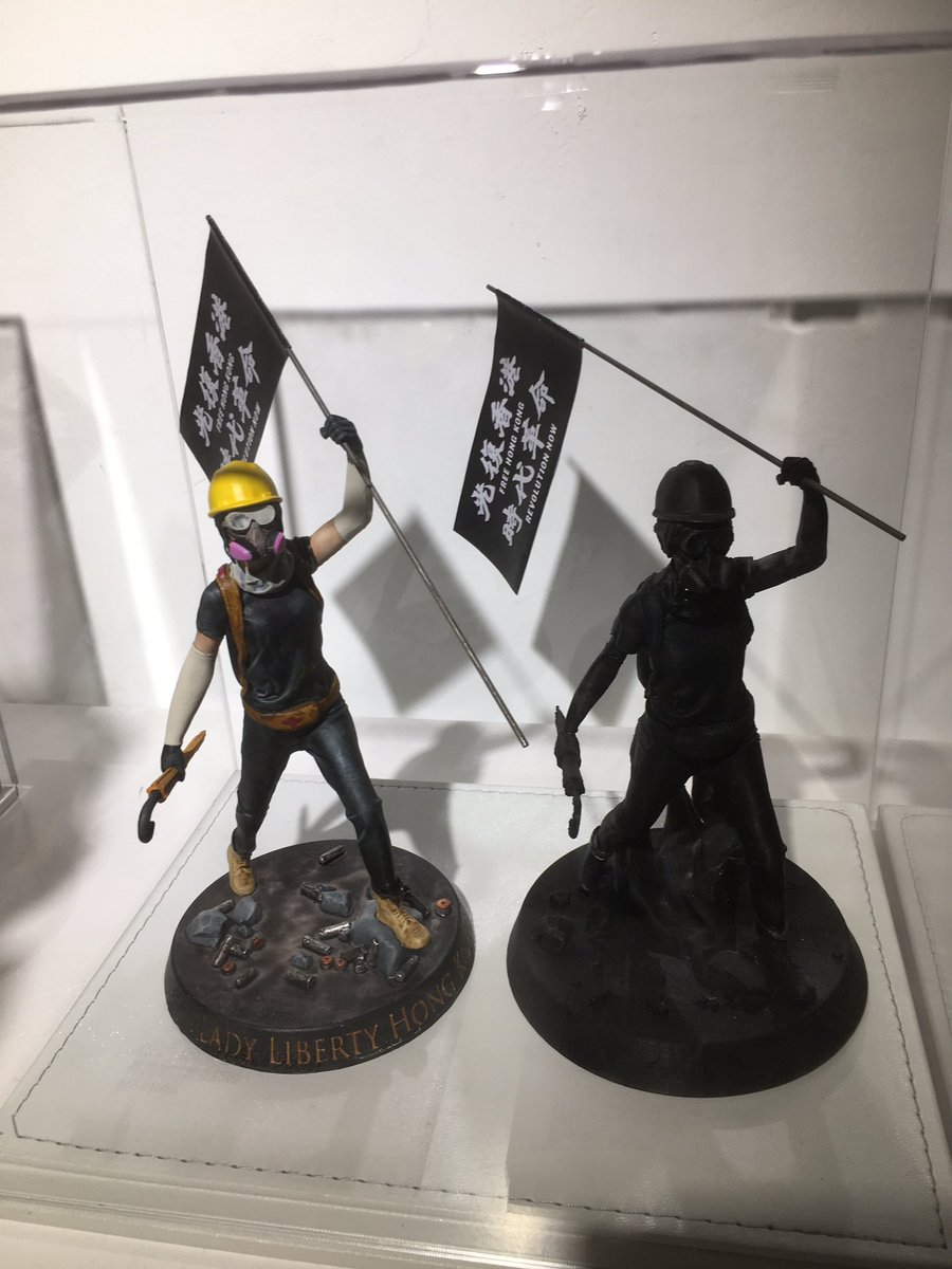 A portion of the exhibit shows how  #LadyLiberty was made, prototypes manufactured with a 3D printer that plays  #GloryToHongKong over and over again.