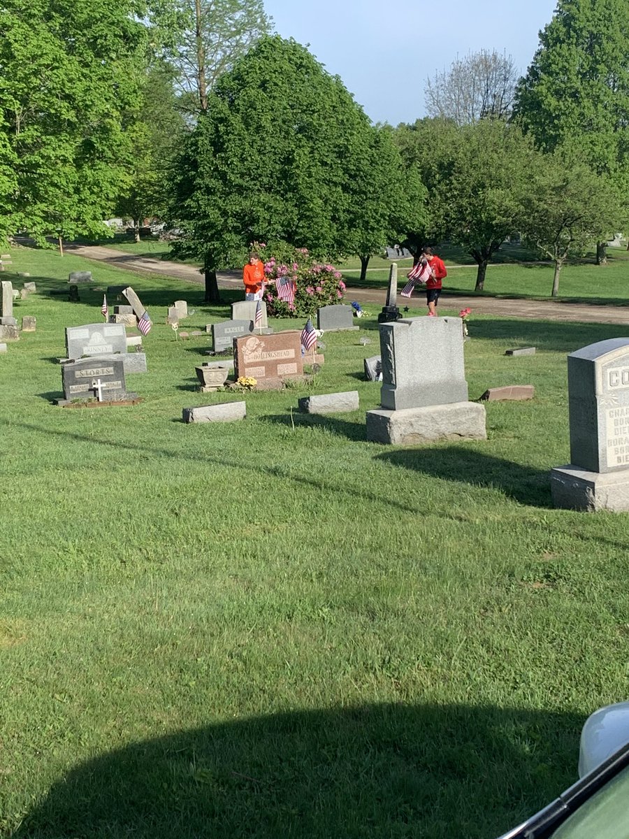 CoachKevinBoard's tweet photo. Varsity Football Players doing their part this morning to remember our Veterans by putting flags out for Memorial Day. 
#ItsBiggerThanFootball https://t.co/ih1l3JkTBr