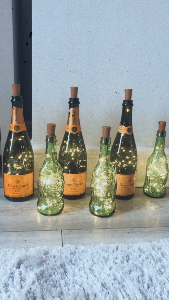 CJBrennan's tweet photo. Tonight’s #quarentinecraft is minimum effort maximum effect! Throwing lots of sparkly lights into our favourite green bottles... guess which one is mine and which is sams 🙄😂🍾 #barlights #gardenbar #craft https://t.co/laVgFloQLf