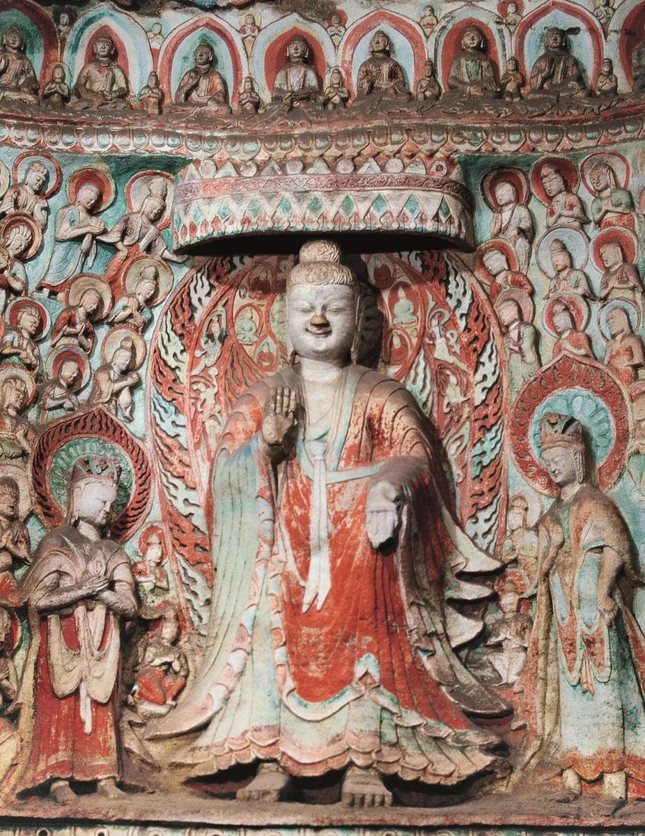 L: Buddha statue in one of the monumental cave chapels sponsored by Xianbei emperors on the city's outskirts (Yungang), dressed in Chinese-style robe & backed by a flaming halo derived from Zoroastrian worship of fire. R: similar statues in Central Asia were called "Buddha-Mazda"