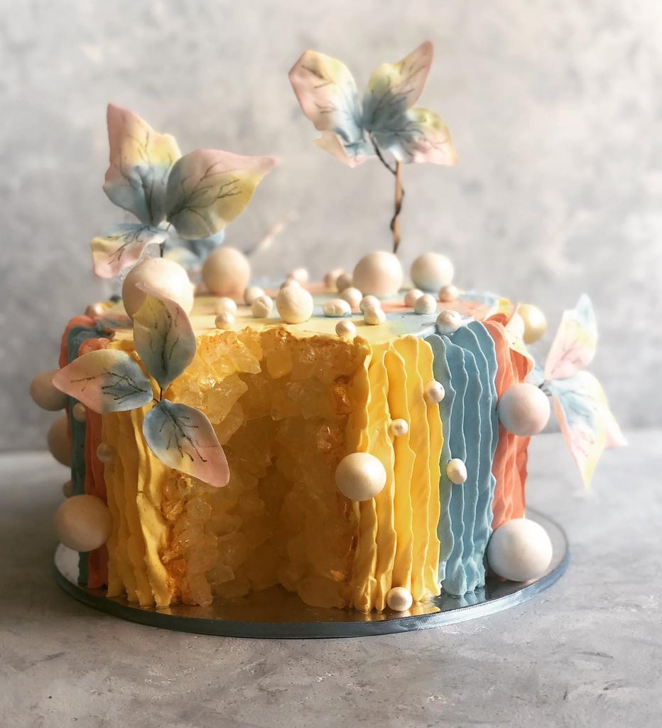 A cake done in two flavors; vanilla mango and chocolate truffle. Ruffles done with whipped cream, edible pearl, edible flowers and geode effect done in pastel hues. ..Check out  http://www.sugartime.in  for more. .. #whippedcreamruffles  #geodeart  #edibleart  #geodecake
