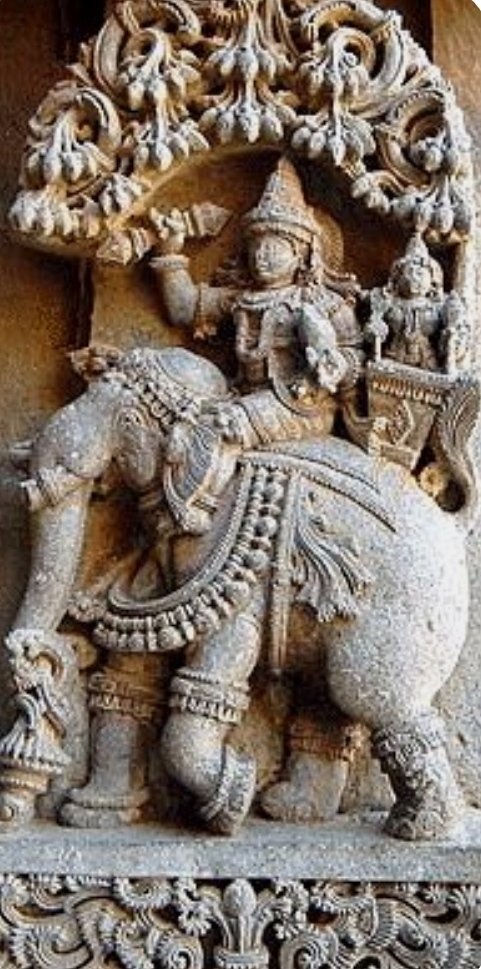 Ill The King Of Gods ~ Indra Dev llMesmerizing image showing Indra Dev, Indrani and his Elephant.Magnificently he is riding on his white Elephant. He is holding his powerful weapon Vajra. He is The king of all the Gods. His consort name is Indrani.Hoysala Temple