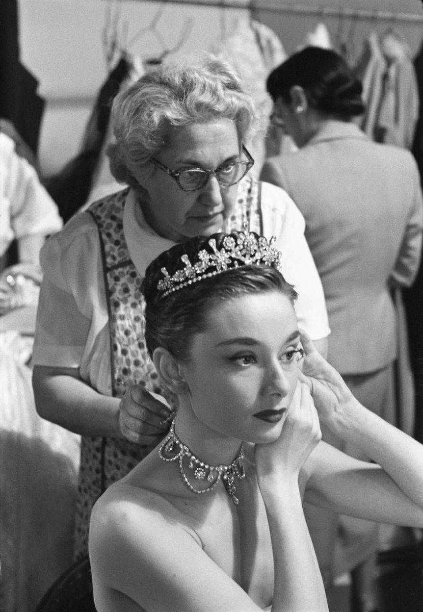 SoAudreyHepburn's tweet photo. Happy #InternationalTiaraDay! 👑

Audrey Hepburn and hairdresser Sally Gordon photographed by Phillip Harrington preparing for a scene for Roman Holiday, 1952 https://t.co/DbNiiM4nEJ