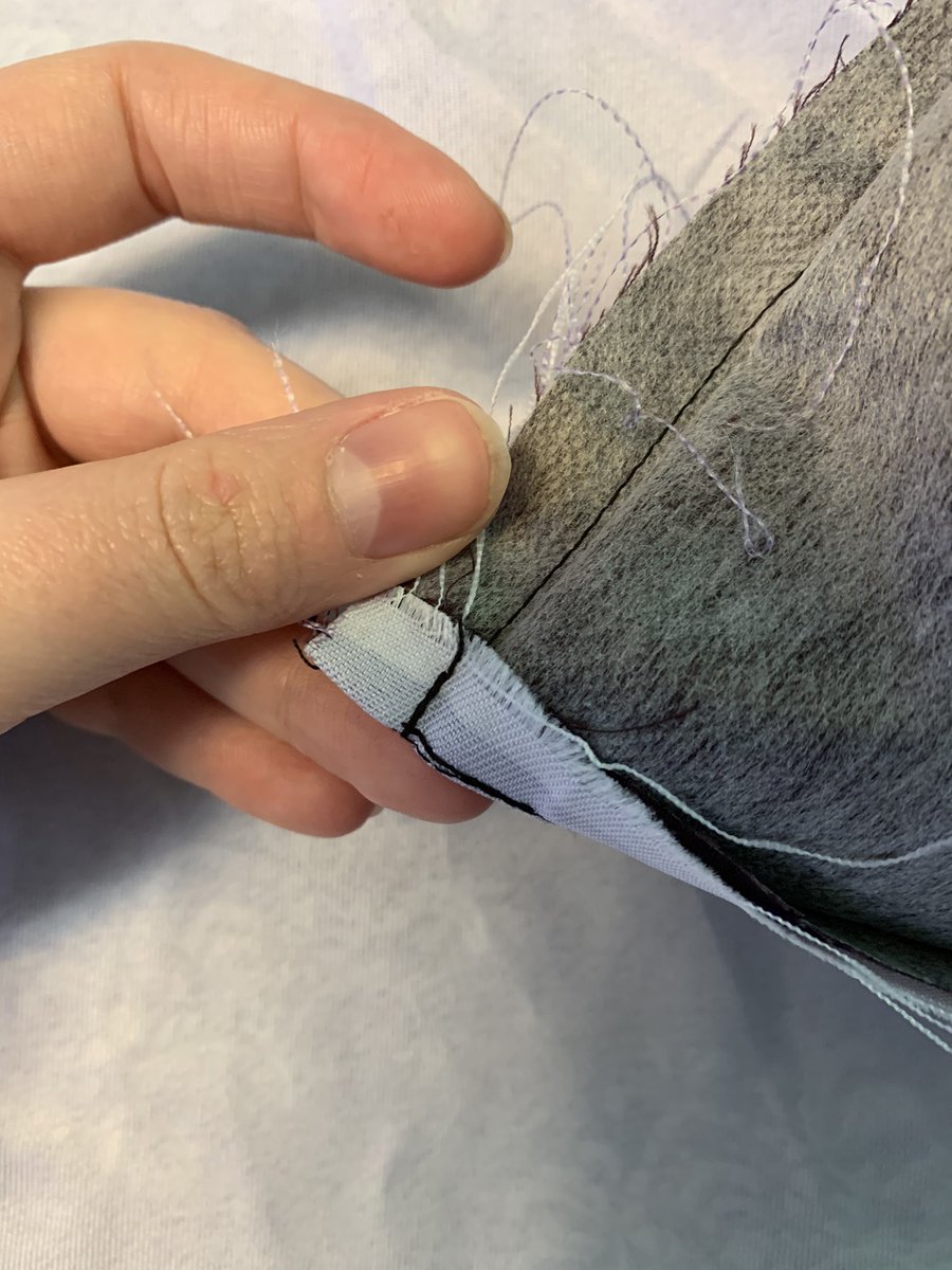 since i’m taking the whole thing apart i’m just gonna pick a spot and go in. i like to find where the stitcher finished a seam and just start from there. CAREFULLY pick up a stitch with your seamripper and start seamripping out the back stitching