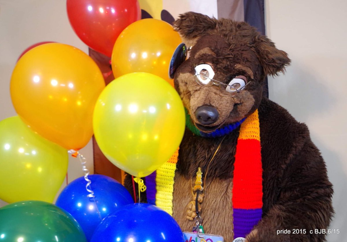 THE_BJBUTTONS's tweet photo. The theme for a past #FWPhotoContest @FursuitersWorld is Pride! Take a #fursuit photo with any kind of item that represent you and the flag you fly! Here is Waldolf with a bunch of #Helium #balloons and a Bear pride flag hanging on the wall behind him #fursuiter #fursuiting https://t.co/hzNwWTS0An