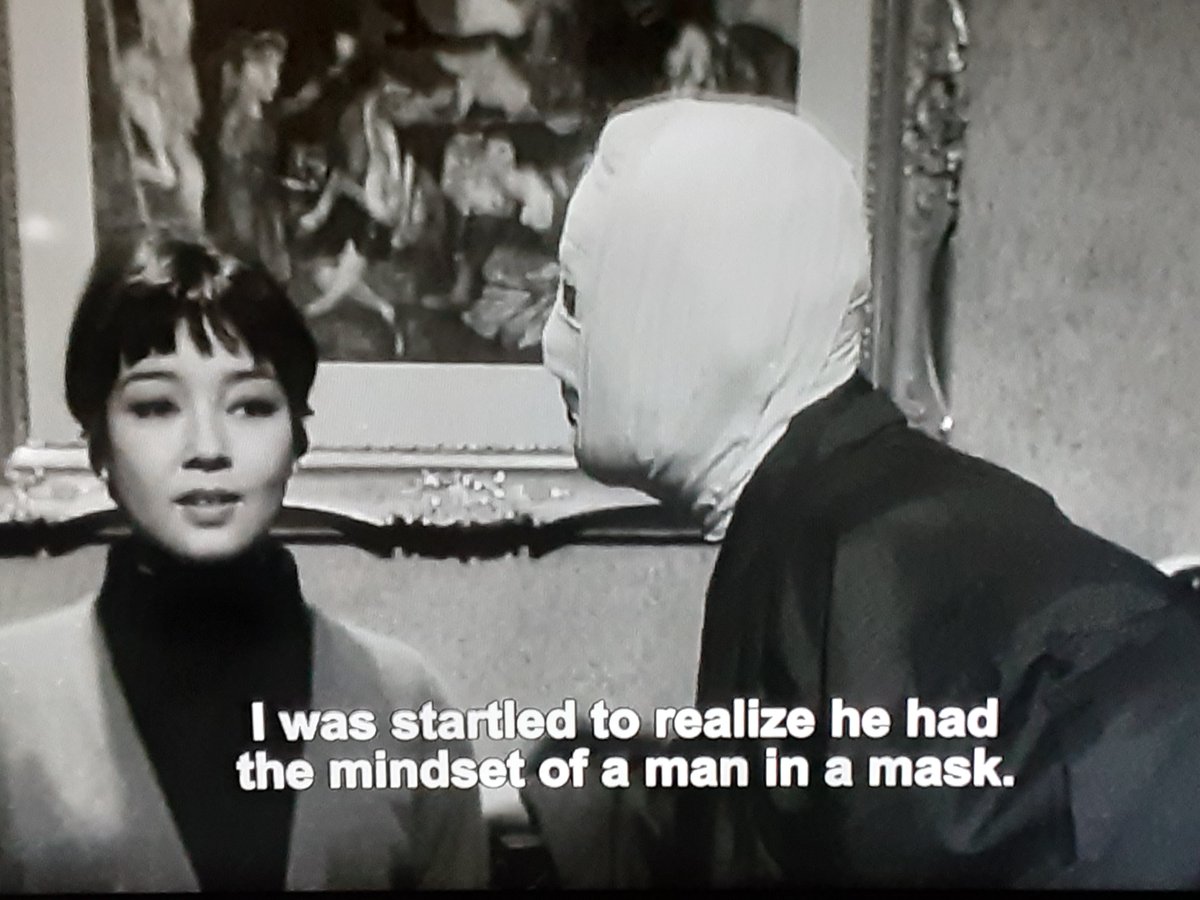 A pivotal surreal scene in the film is litterally a man escaping into a crowd of people in faceless masks