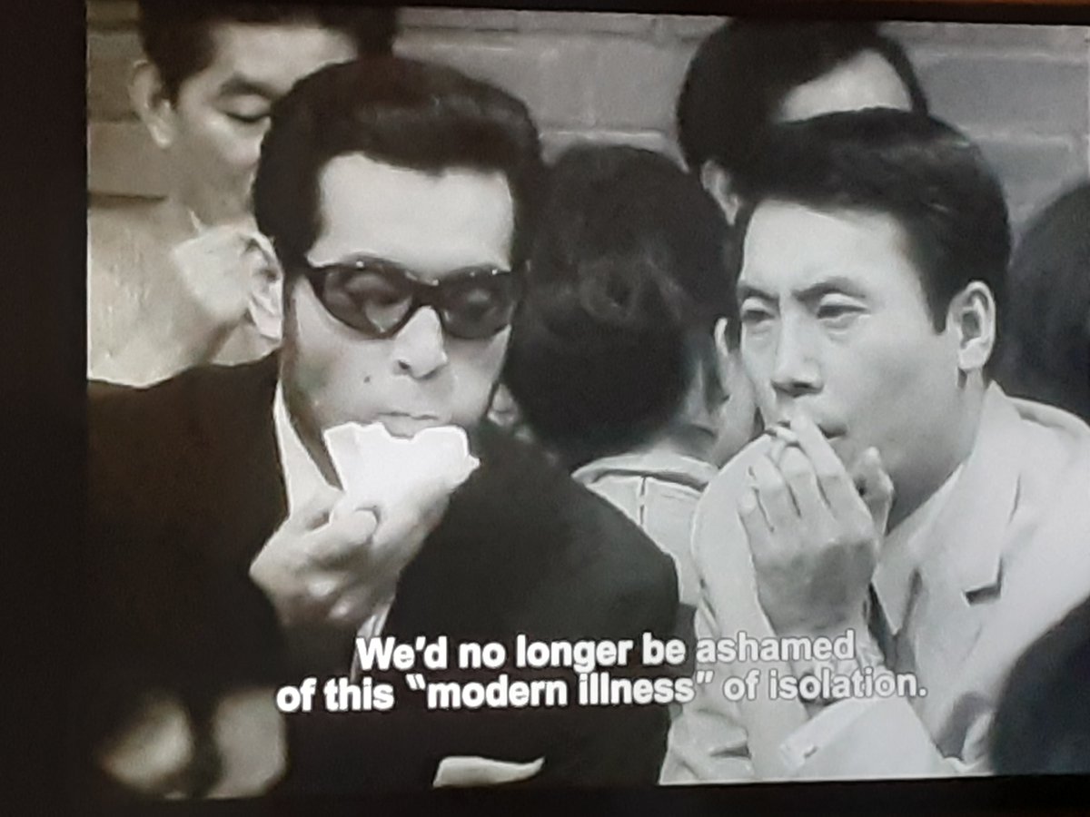 One of my favorite scenes in the movie. Love the way the crowd, sound of the german beer hall (were german beer halls in japan a thing in the 60s?) fall away as their conversation becomes more intimate and serious.Points about masks and solitude relevant to our quarentine world