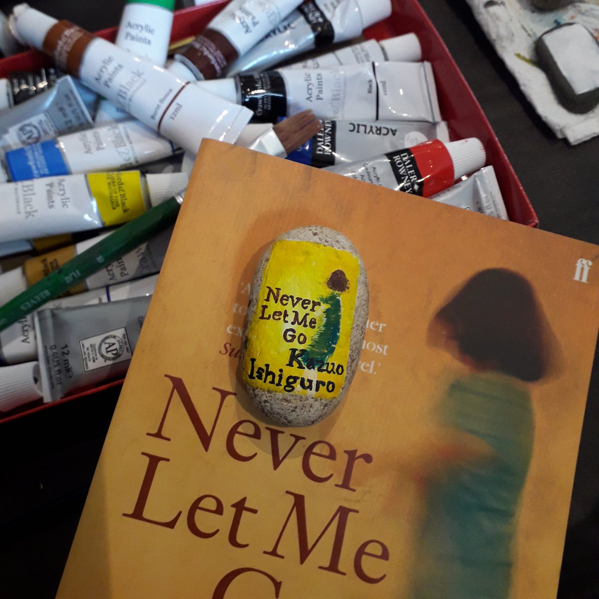 Never Let Me Go by Kazuo Ishiguro painted on a pebble