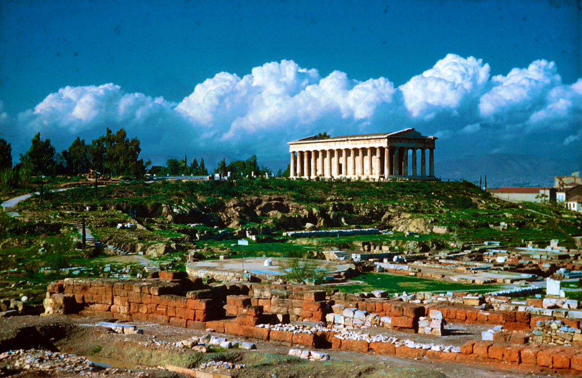 The temple sits atop the Kolonos hill at the east end of the Agora & was linked woth industrial activity on this end of the city.The site is so lush today that the Hephaisteion is tough to photograph in full, luckily you can always count on the@ASCSAthens photo archives!