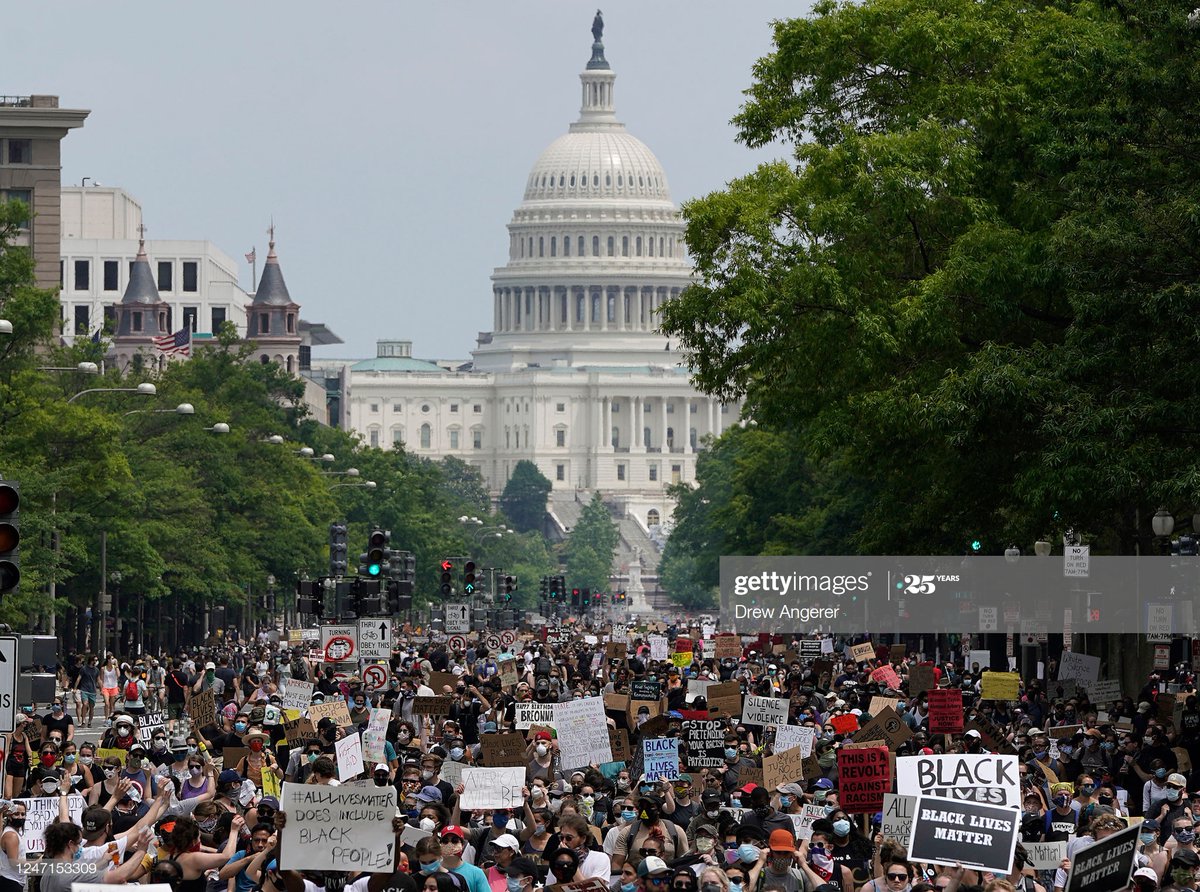 Demonstrators march down Pennsylvania Avenue in front the U.S. Capitol