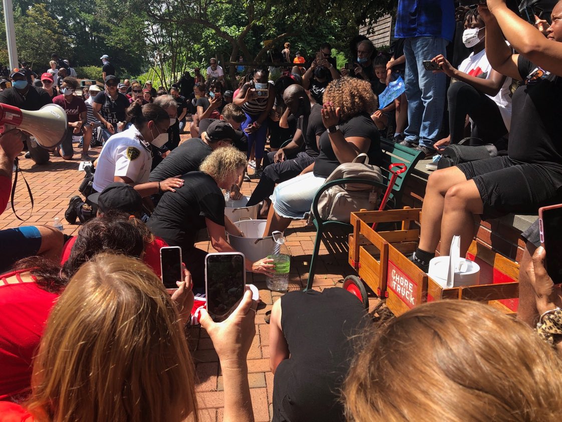 MattWalshBlog's tweet photo. This is real. White people bowed and washed the feet of two black pastors at a march in NC. While washing the feet they apologized on behalf of the white race.

Let me be the first to say: you don’t apologize on my behalf. I don’t owe one and don’t offer one. This is lunacy. https://t.co/ASEQaRKyWN
