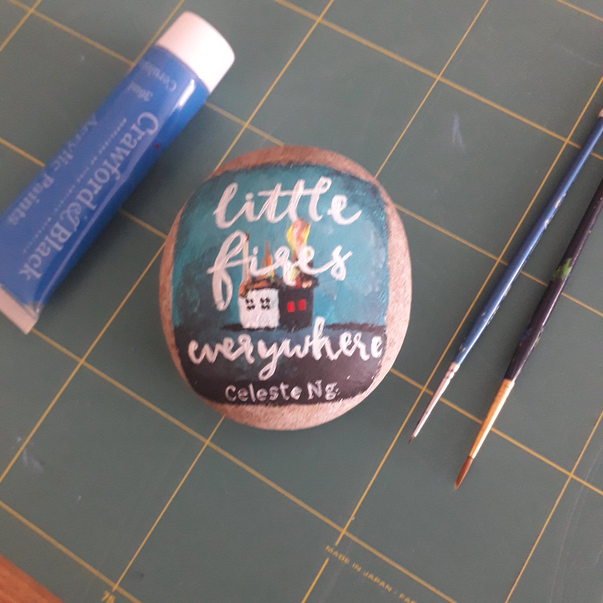 Little Fires Everywhere by Celeste Ng  @pronounced_ing painted on a rock  #LittleFiresEverywhere