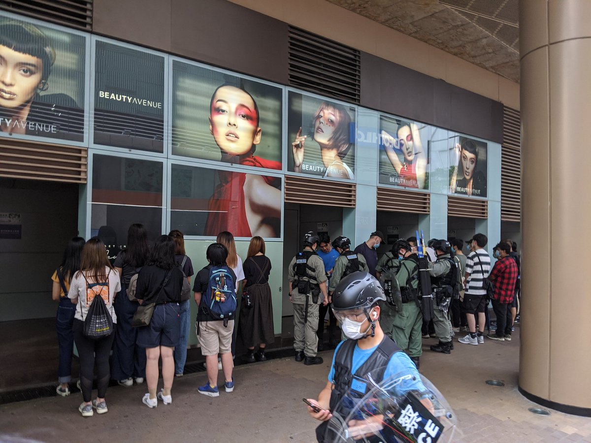 From a closer angle:These people were detained approximately half an hour ago (15:00), when riot police made a charge in Mong Kok around Nathan Road and Langham Place.