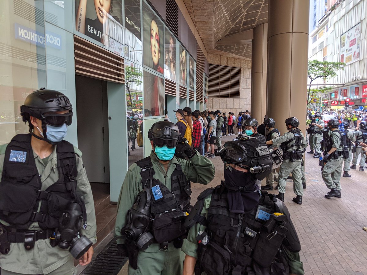 From a closer angle:These people were detained approximately half an hour ago (15:00), when riot police made a charge in Mong Kok around Nathan Road and Langham Place.