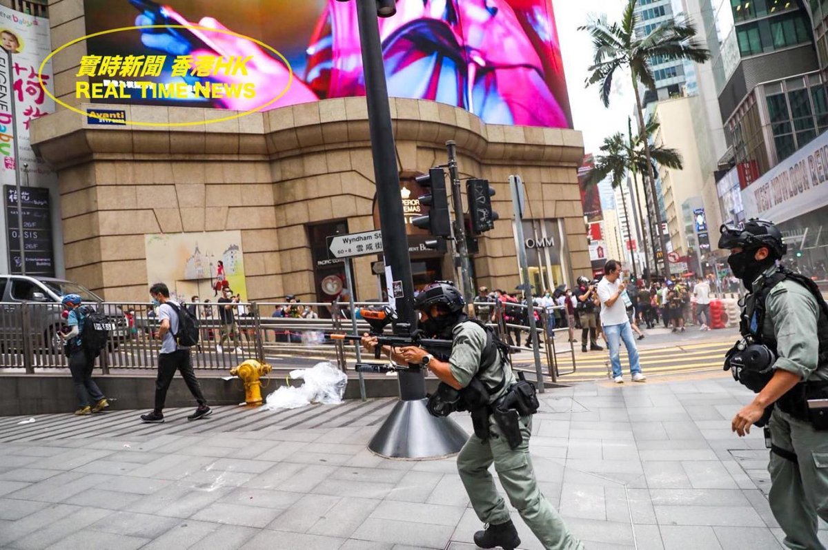 VerbatimHKG's tweet photo. Asia's finest: riot police seen joyfully shooting at protesters this afternoon. 

Riot police laughed hysterically as he fired pepper ball rounds to the crowd. You can see his heightened excitement through his eyes.

Source: Real Time News HK

#PoliceBrutality #HongKongProtests https://t.co/wij7njIAbb