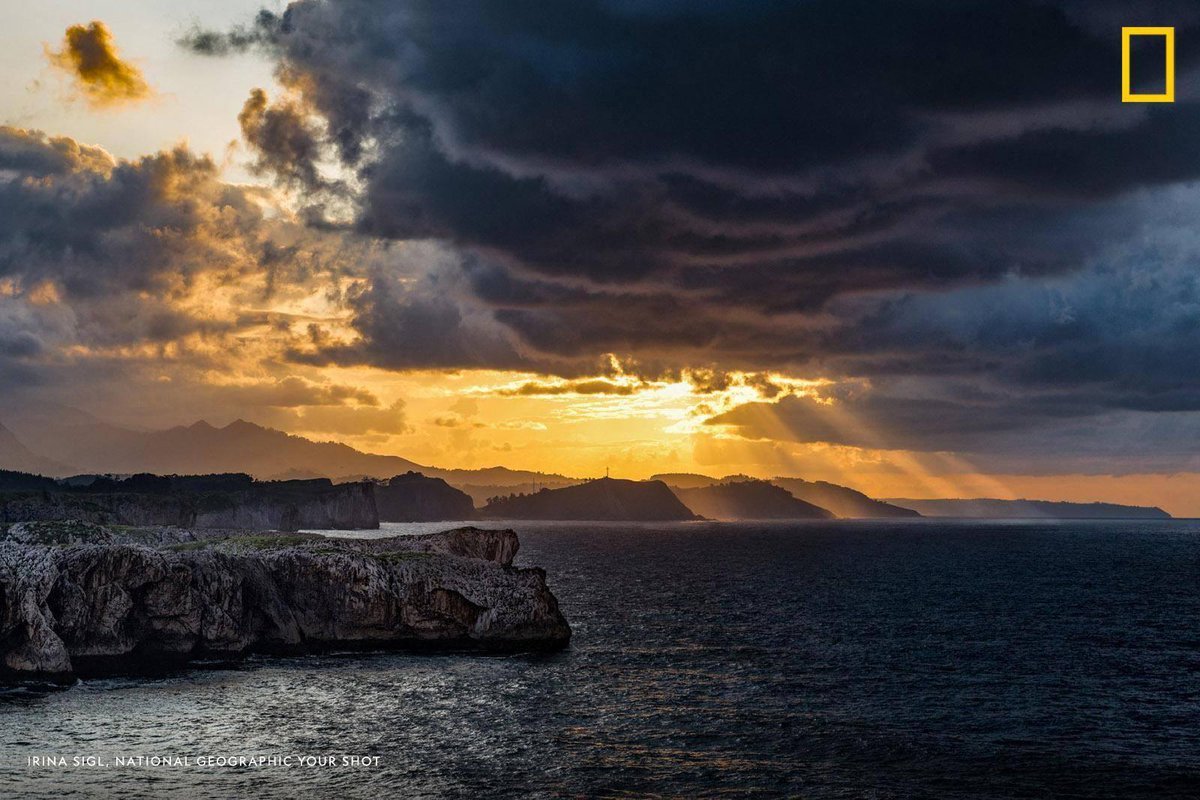 NatGeoTravel's tweet photo. "What a great sky spectacle," muses #YourShot photographer Irina Sigl, who captured this golden sunset emerging after a storm off the coast of Asturias, Spain. https://t.co/RoX3afsL8s
