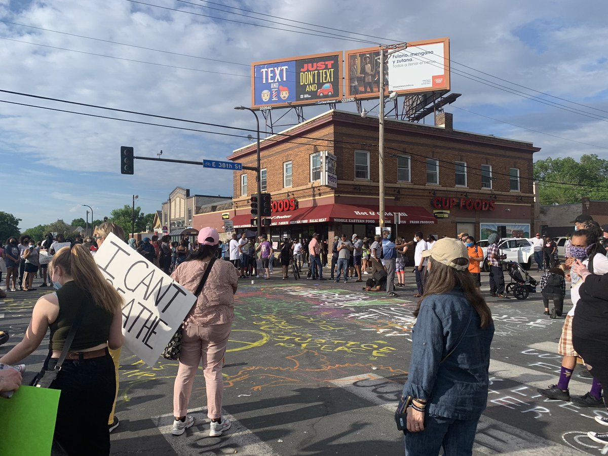 Went and talked with a couple people who knew  #GeorgeFloyd. Returned to 38th and Chicago about 6:15 pm and the crowd has gotten bigger. More signs, louder music but very peaceful. Jade Sheriff, 32 (pictured) is holding her sign in hopes to protect her two children.