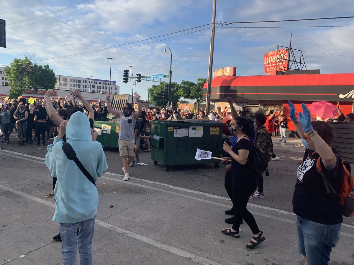 Minneapolis police officers l firing multiple projectiles and noise devices as protesters move dumpsters closer to the baracades in front of the precinct.  #GeorgeFloyd