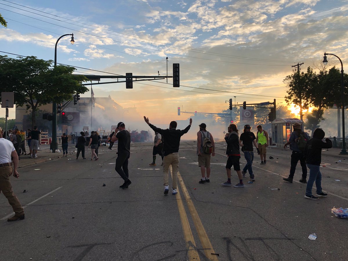 Tear gas fired. Protesters regroup with milk and what appear to be to pick-ups full of barricade supplies