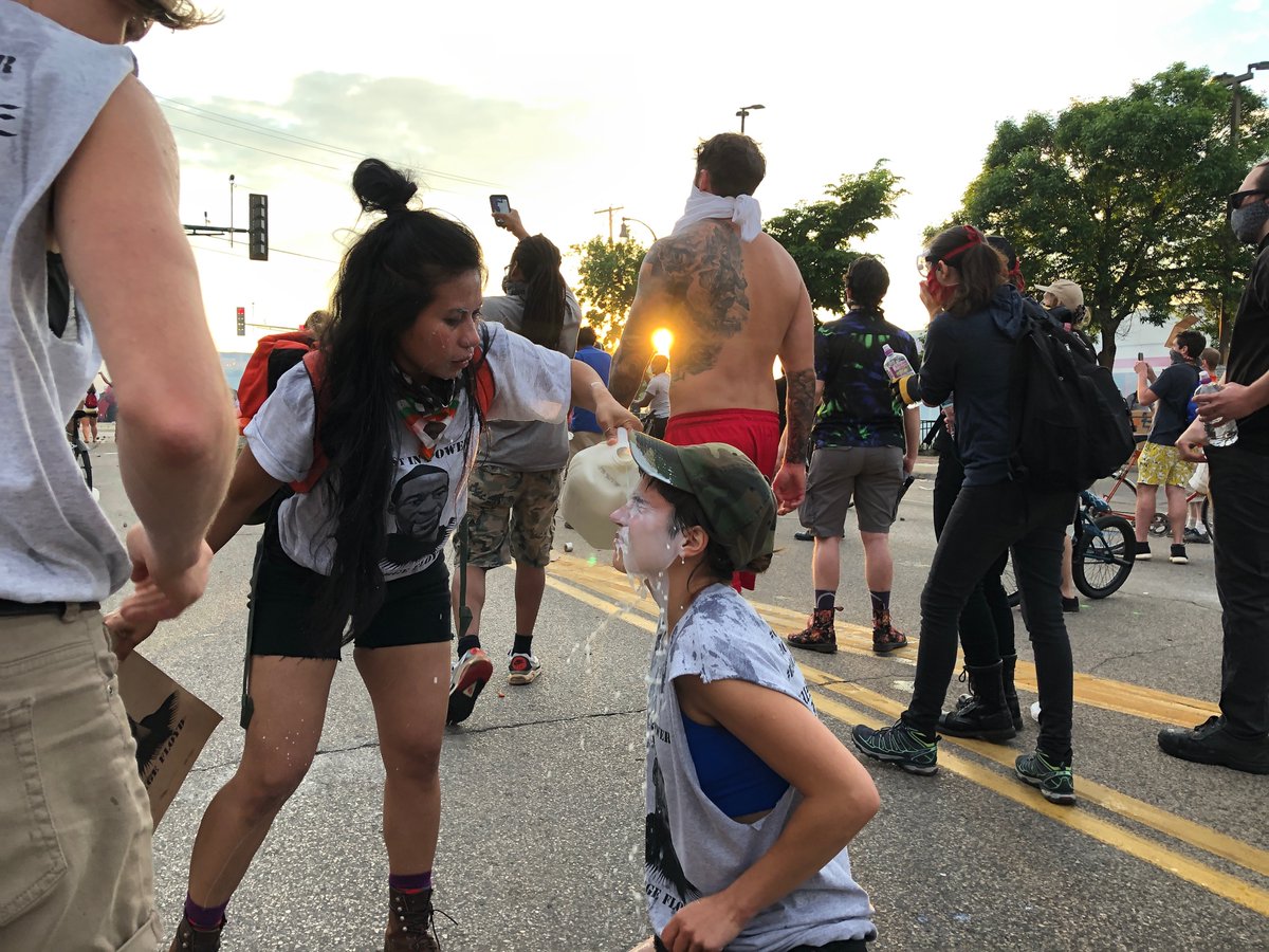 Tear gas fired. Protesters regroup with milk and what appear to be to pick-ups full of barricade supplies