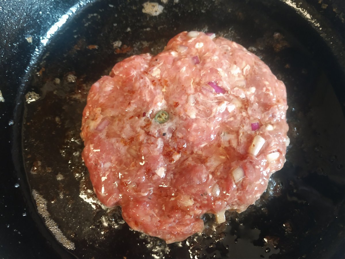 Add the patty carefully (watch the splatter). Then just let it sit, unmolested. Some folks like to press down on it. Don't. Takes the juices away. Just let it cook at medium heat to your preferred level of doneness (medium for us). Even after flipping, DO NOT PRESS!