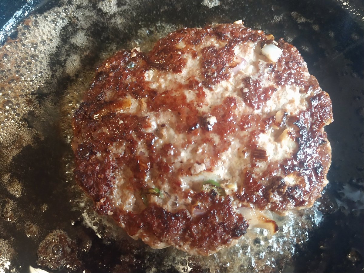 Add the patty carefully (watch the splatter). Then just let it sit, unmolested. Some folks like to press down on it. Don't. Takes the juices away. Just let it cook at medium heat to your preferred level of doneness (medium for us). Even after flipping, DO NOT PRESS!