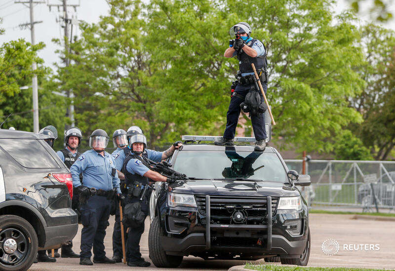 A police officer aims before firing at protesters gathered near the Minneapolis Police third precinct. More photos from last night's demonstrations over the death of George Floyd:  http://reut.rs/3db5SAJ   Eric Miller
