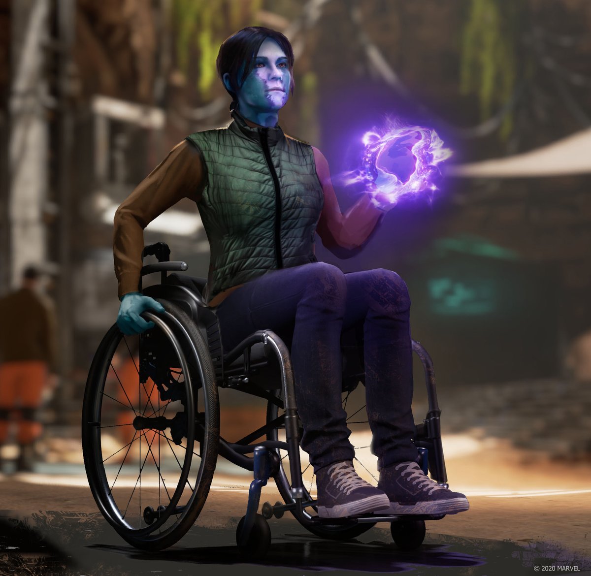 A concept art image of  an individual with short dark hair and two-toned  blue/purple skin. She is sitting in a wheelchair, wearing sneakers, jeans, a long-sleeved  shirt, and green vest. Purple energy is emitting from her  hand as she looks off into the distance. Blurry figures in orange and brown clothing stand behind them. Greenery and the glow of a digital screen can be seen in the far background.