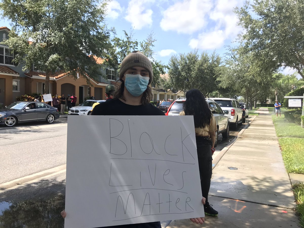 Jake Uttich, 23, came from Oviedo to stand in front of the officer’s home. He wears a mask and has a Black Lives Matter sign. “You can only retweet things so many times.” He wanted to do something.  #GeorgeFloyd