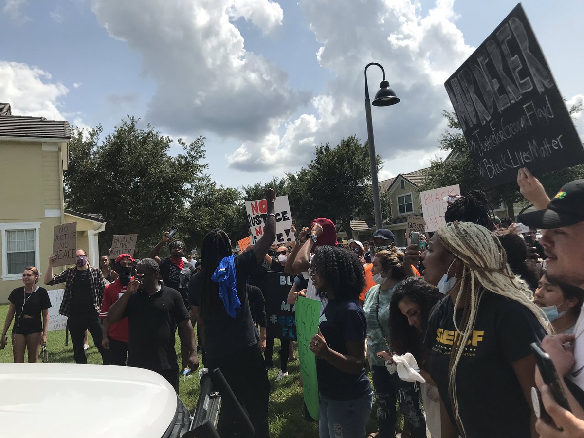 Protestors march down the block, which  @OrangeCoSheriff has blocked off at one end. They went up to a deputy in his car, yelling, “no justice, no peace, no racist police” and “say his name,  #GeorgeFloyd”Other deputies stood by.