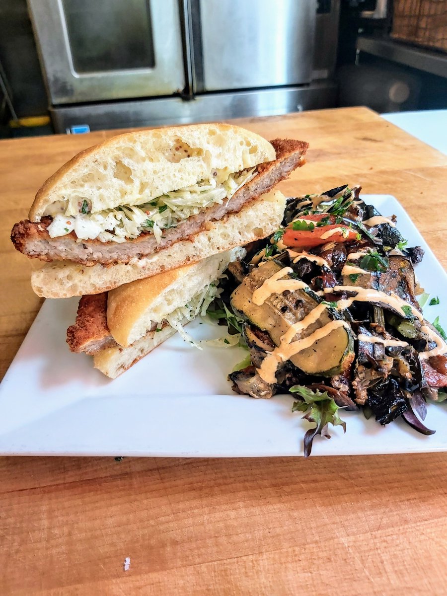 Enjoy our beloved schnitzel sandwich (breaded and fried in-house) next to our new grilled veggie salad! #bunaskitchen #wedeliver🚐🚙 #takeouttoronto #torontodotcom #torontorestaurants #chewtoronto #doordash #ritualtoronto #tastethesix #tastetoronto