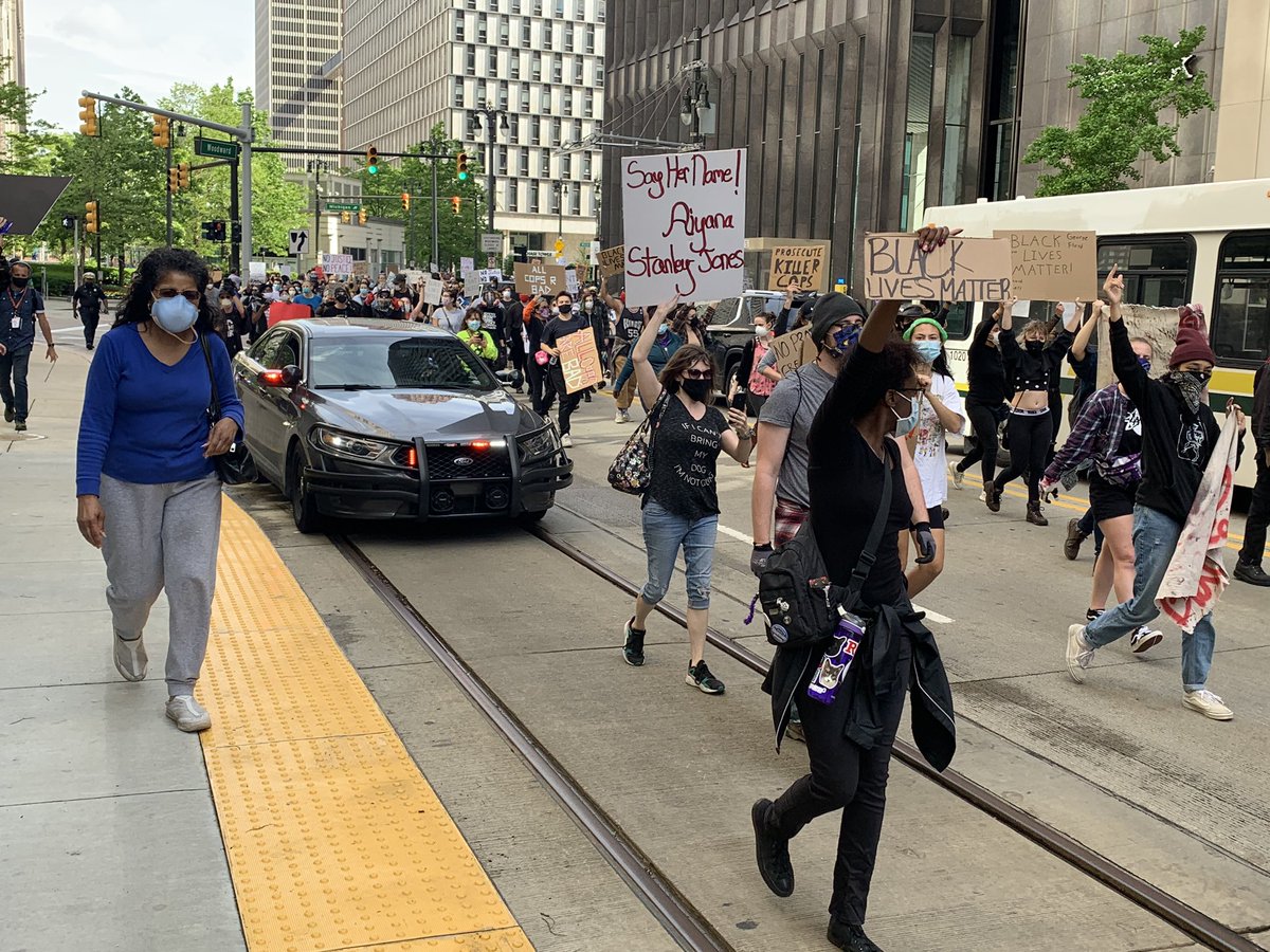 The marchers keep screaming “Take the streets.” DPD wants them on the sidewalk. They have flooded Woodward Avenue headed north near the Nike store. DDOT is trapped and cars and honking for them to move. Dr. King took this route in reverse in 1963 during the Walk to Freedom.