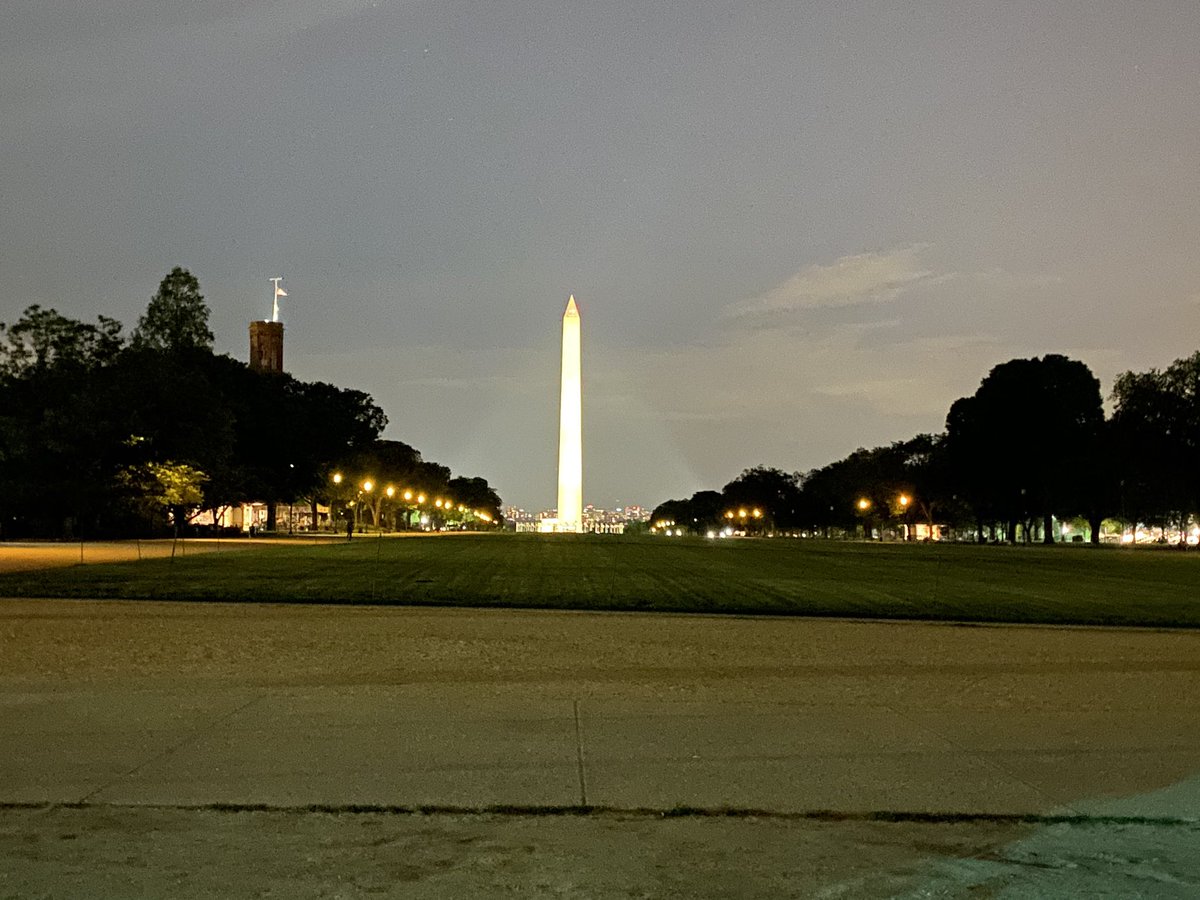 Some lightening flashes behind the monument as the group continues on