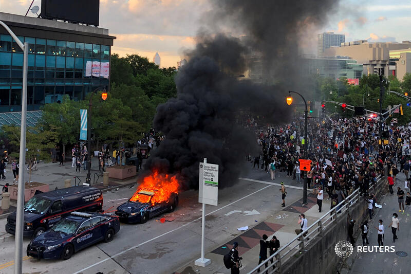 An Atlanta police car burns in the aftermath of protests over the police killing of George Floyd, near CNN Center in Georgia. More from protests around the country:  https://reut.rs/3gyKibD    @dustchambers