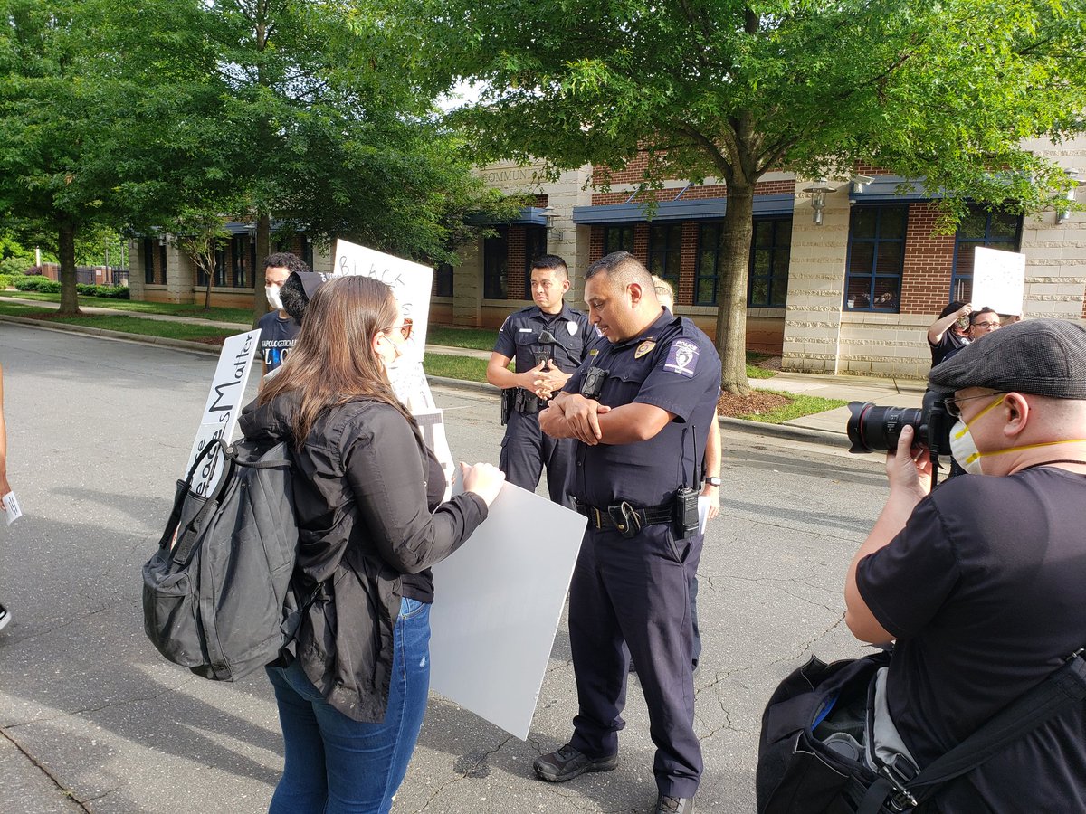 There about 10 officers out front milling about asking protesters individually if they'd like to talk.