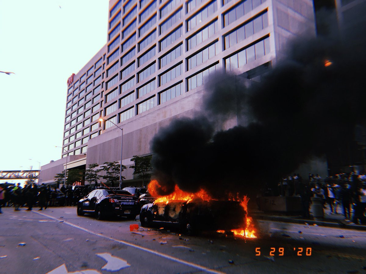 People chant “no justice, no peace” as an APD vehicle burns in front of CNN center in ATL.