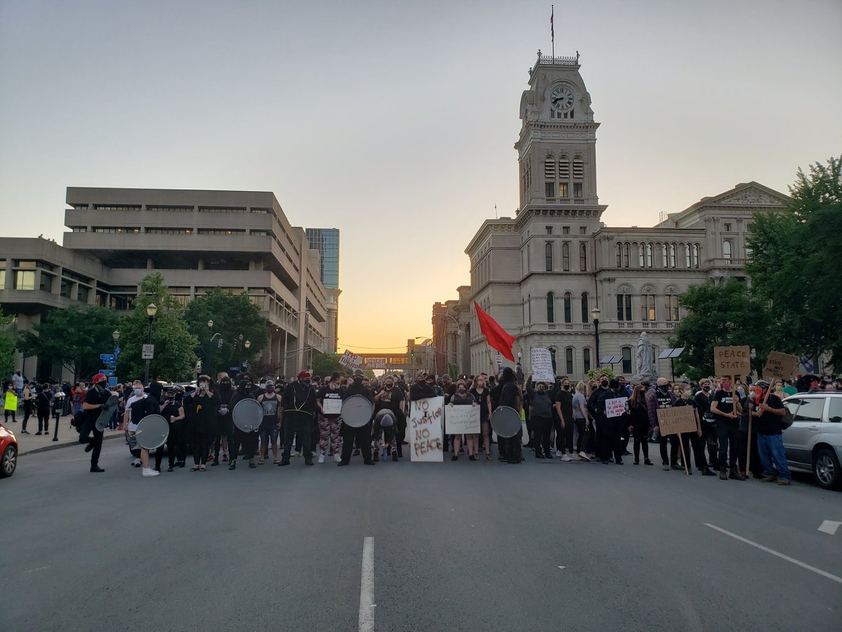 Each lap for  #BreonnaTaylor, a line of predominantly white people block them from any traffic."The Change Is Gonna Come" is playing softly from a Bluetooth speaker.