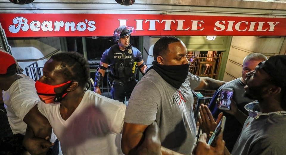 TheyCallMeNov's tweet photo. Tell this story. 

A group of black men ensure no harm comes to a police officer in #LouisvilleProtests.

#Louisvilleprotest #protests https://t.co/nJ1NSQUY3v