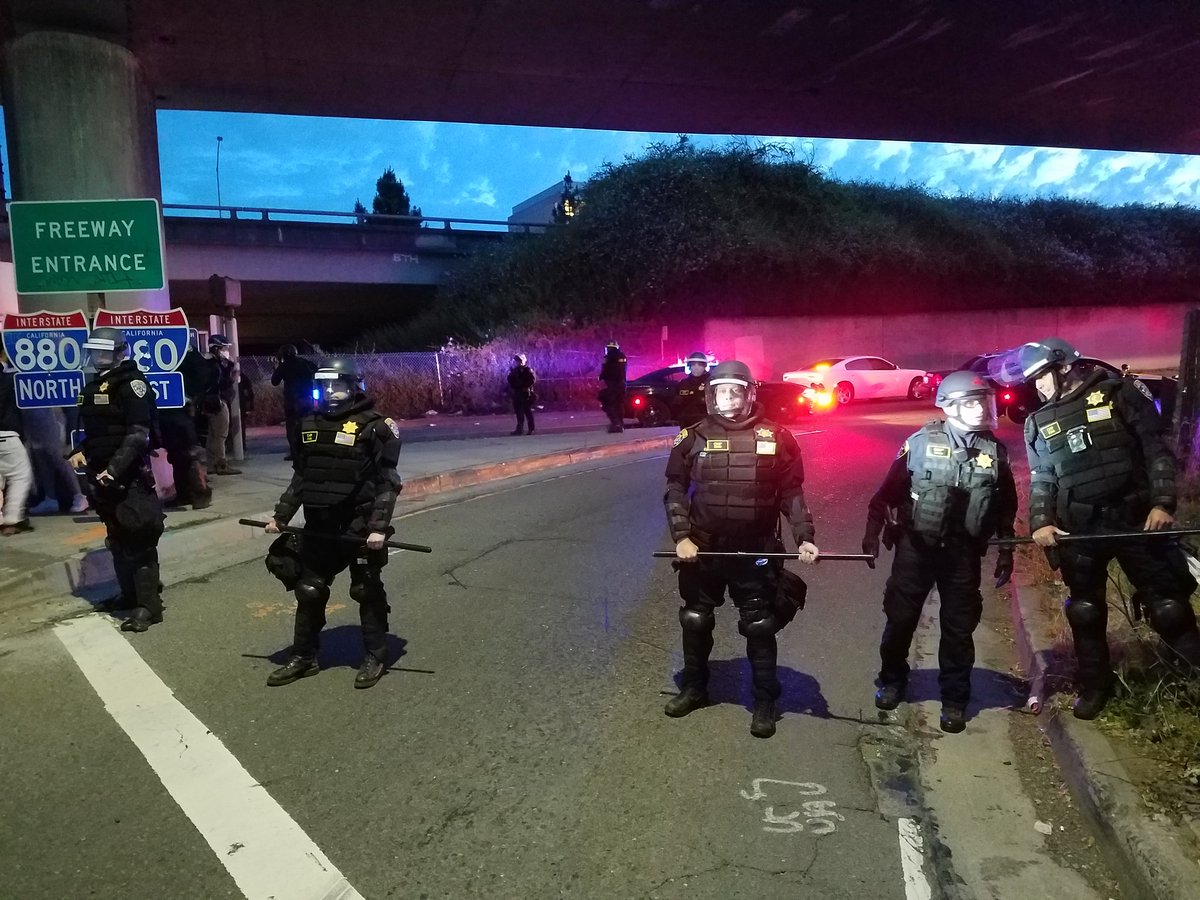 CHP in riot gear are blocking freeway onramp.