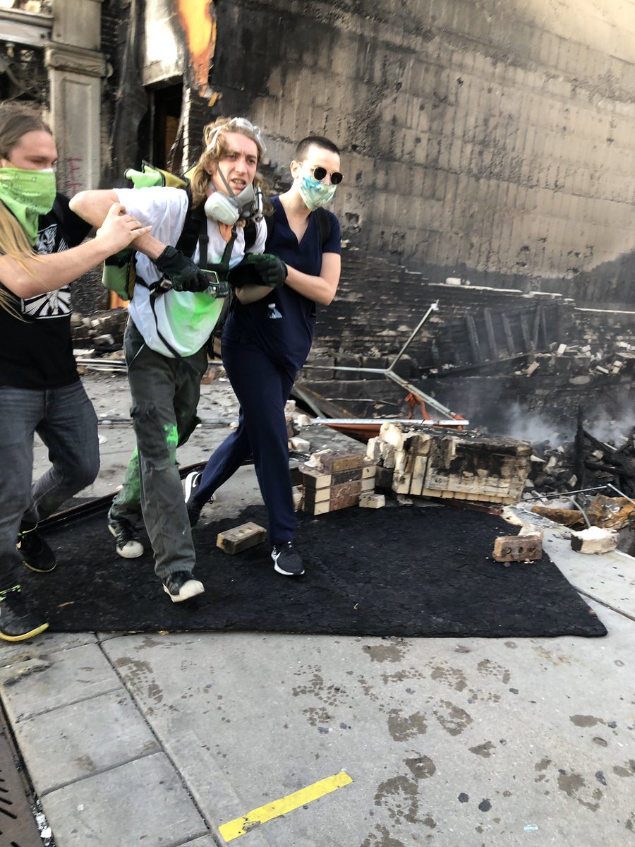 I was tear gassed today. With dozens of other peaceful protestors as we kneeled on our knees and begged. BEGGED not to be harmed. The person being carried in the second photo was shot in front of my eyes with rubber bullets by police.