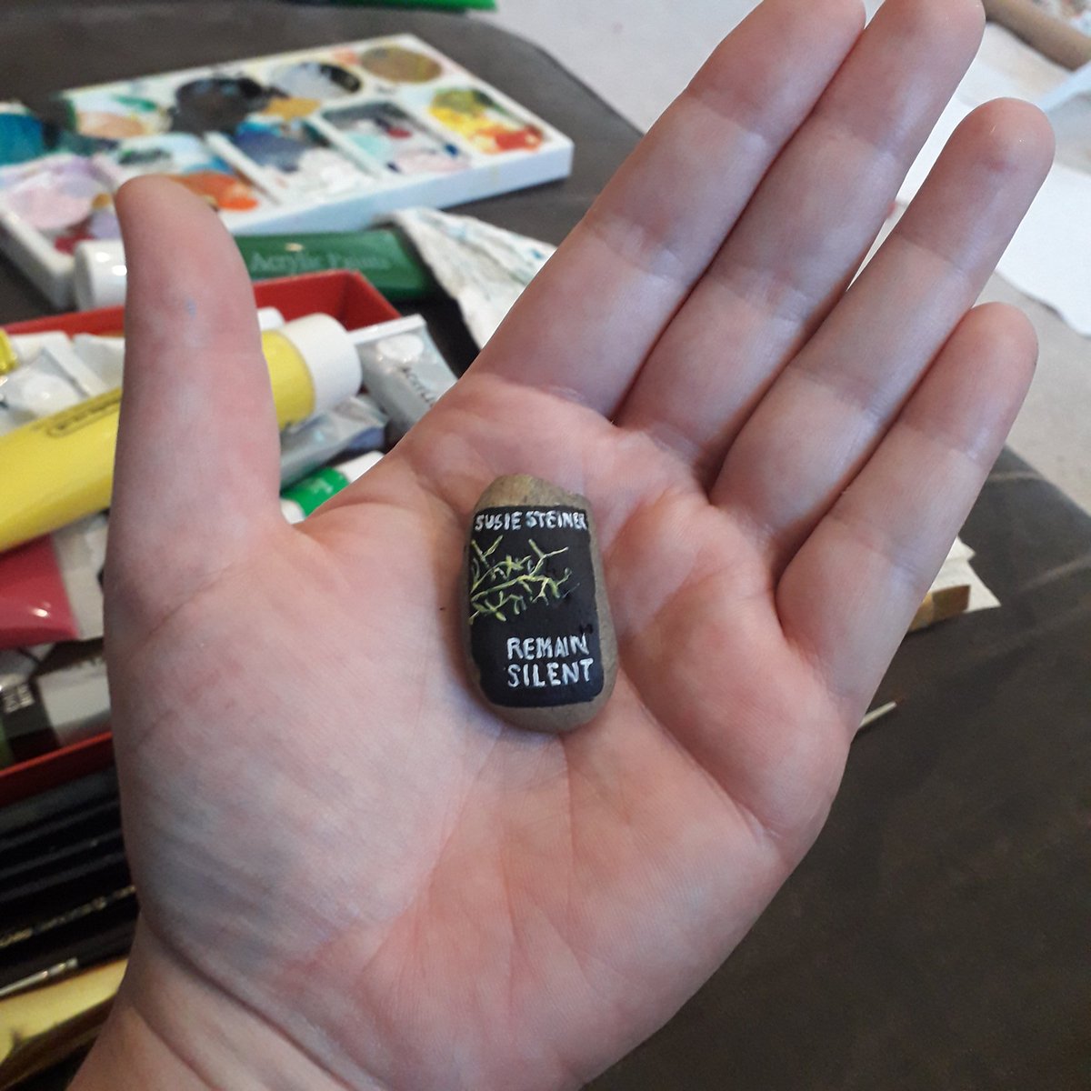 Remain Silent by  @SusieSteiner1 painted on a pebble to be hidden in my library. Good luck with the launch! I've definitely gone too small with the rock again.