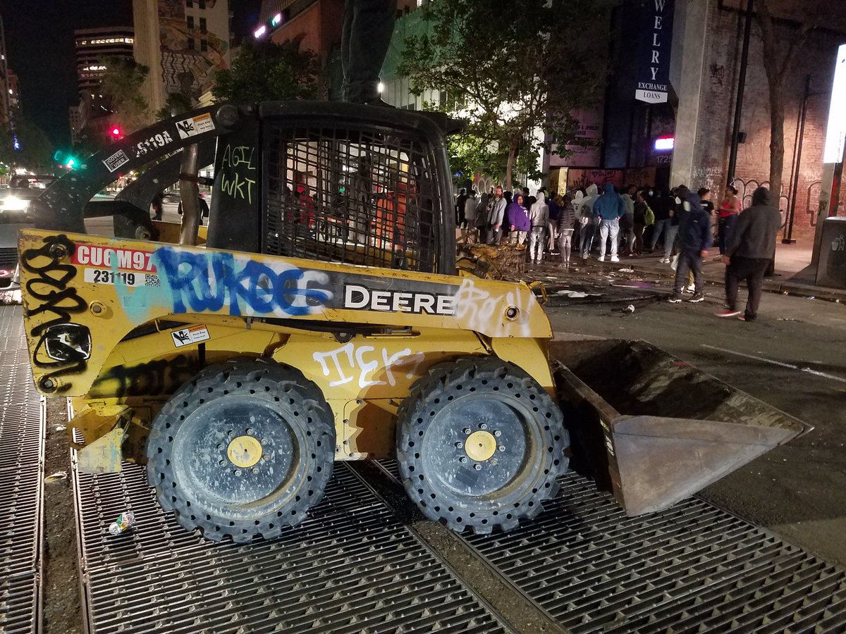 Mini bulldozer and torched traffic signal in the middle of Broadway.