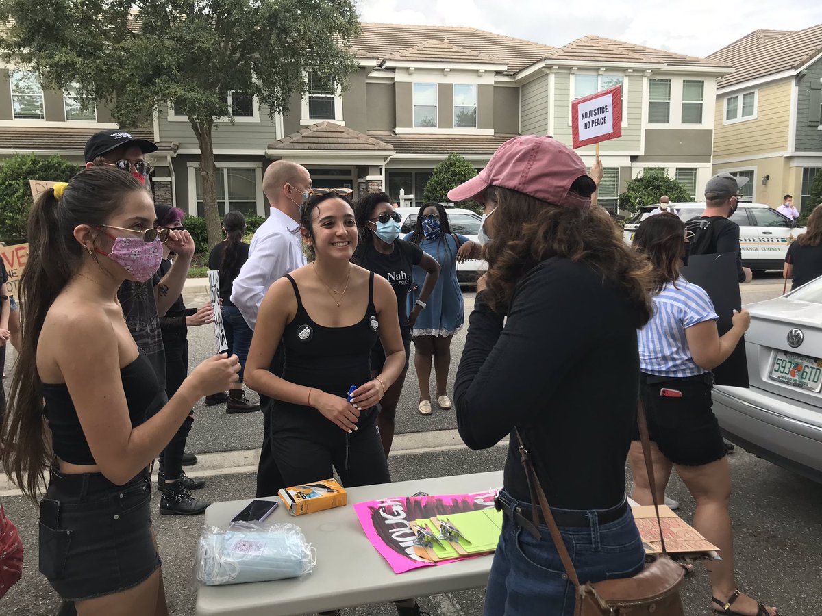A table set up by local organizers for  @Dreamdefenders, giving out water, masks, collecting people’s names/numbers. We’re trying to “move people from protesting... to a little bit more direct action,” said Marissa Echeverria, a leader of the group (center)