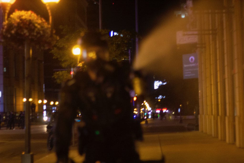Last night, I was walking to my car on High Street in Downtown Columbus. A SWAT officer chased me on his bike for about a block while I was sprinting away. I had my hands up and a camera in hand. He told me it was “too fucking late” to leave. He maced me three separate times.