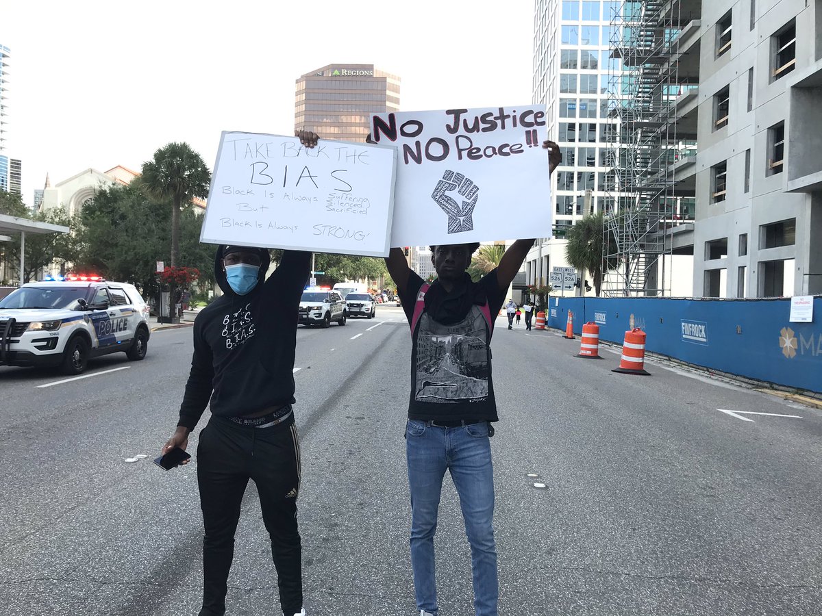 I walked here with Matthew Xavier Smith (right) and Benny Williams. They were glad to see so many people out AND how the cops were working with them to block off streets. “They’re letting us have our space,” Smith, 20, said.