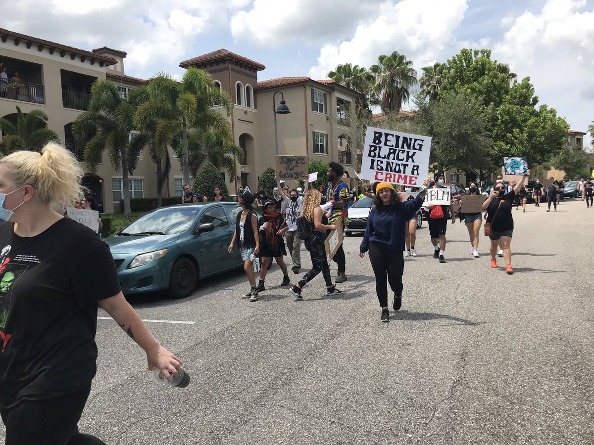 And very quickly, the demonstrators head down the road, calling for people to meet in downtown Orlando to continue the protests at Lake Eola. They walk down the street then start getting in cars. People hold signs out their cars as they head out of the neighborhood.
