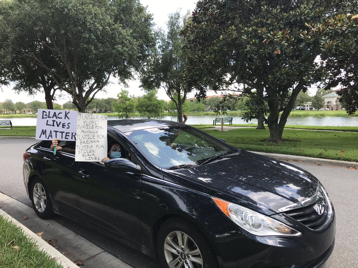And very quickly, the demonstrators head down the road, calling for people to meet in downtown Orlando to continue the protests at Lake Eola. They walk down the street then start getting in cars. People hold signs out their cars as they head out of the neighborhood.