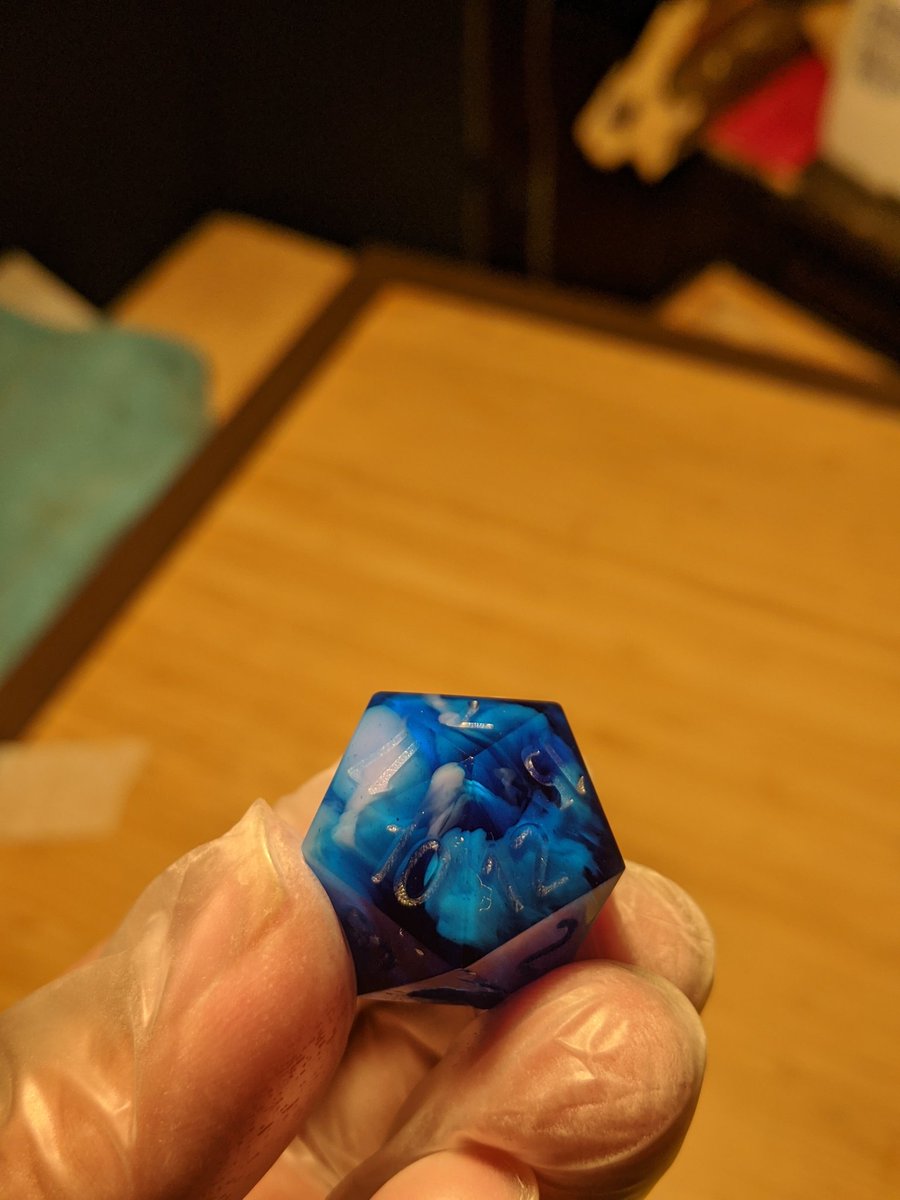 Daikondice's tweet photo. Swirling suspended pink encased in a deep clear blue. 
Unfinished and uninked!
#dice #handmadedice #resin #resinart #dnd #dnd5e #ttrpg https://t.co/VpTbwmSmpd
