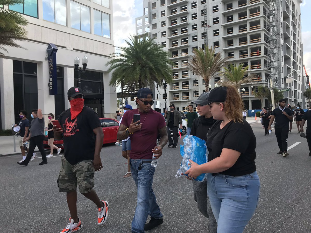 Roommates Jessica Langdale and Lacy Jones bought cases of water to give out as people protest. They also have a first aid kit. “I can’t begin to understand what ... black men’s and women are going through everyday,” Langdale (right) said. But she wanted to show support.
