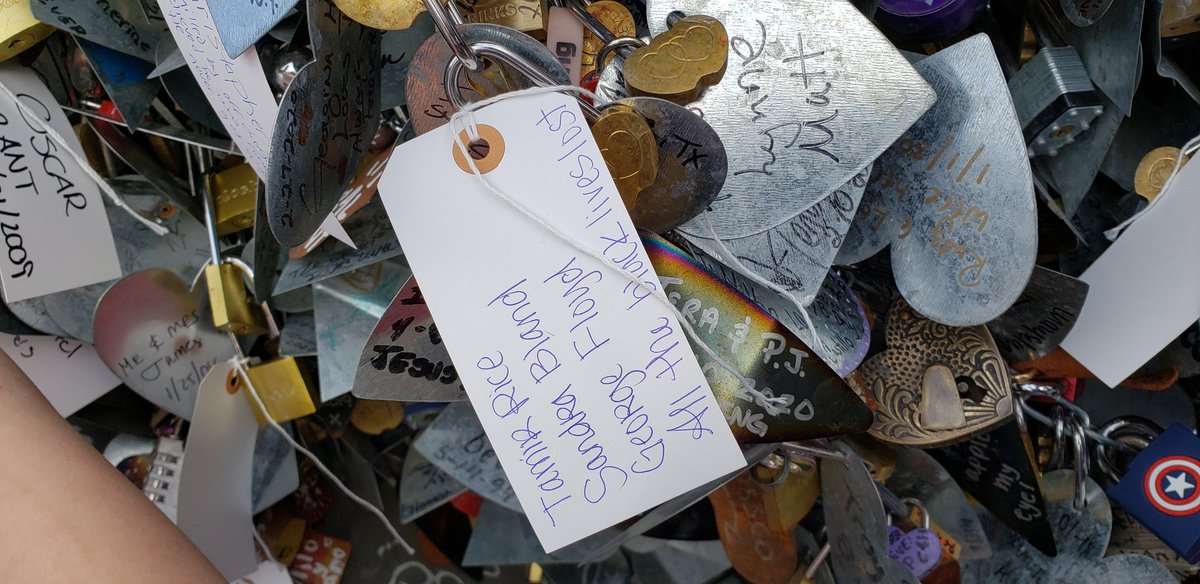 People are writing the names of those affected by police brutality on toe tags and placing them on a statue.